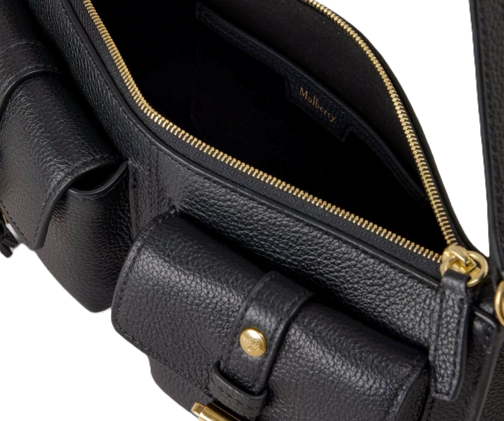 Black leather handbag with gold accents on a white background