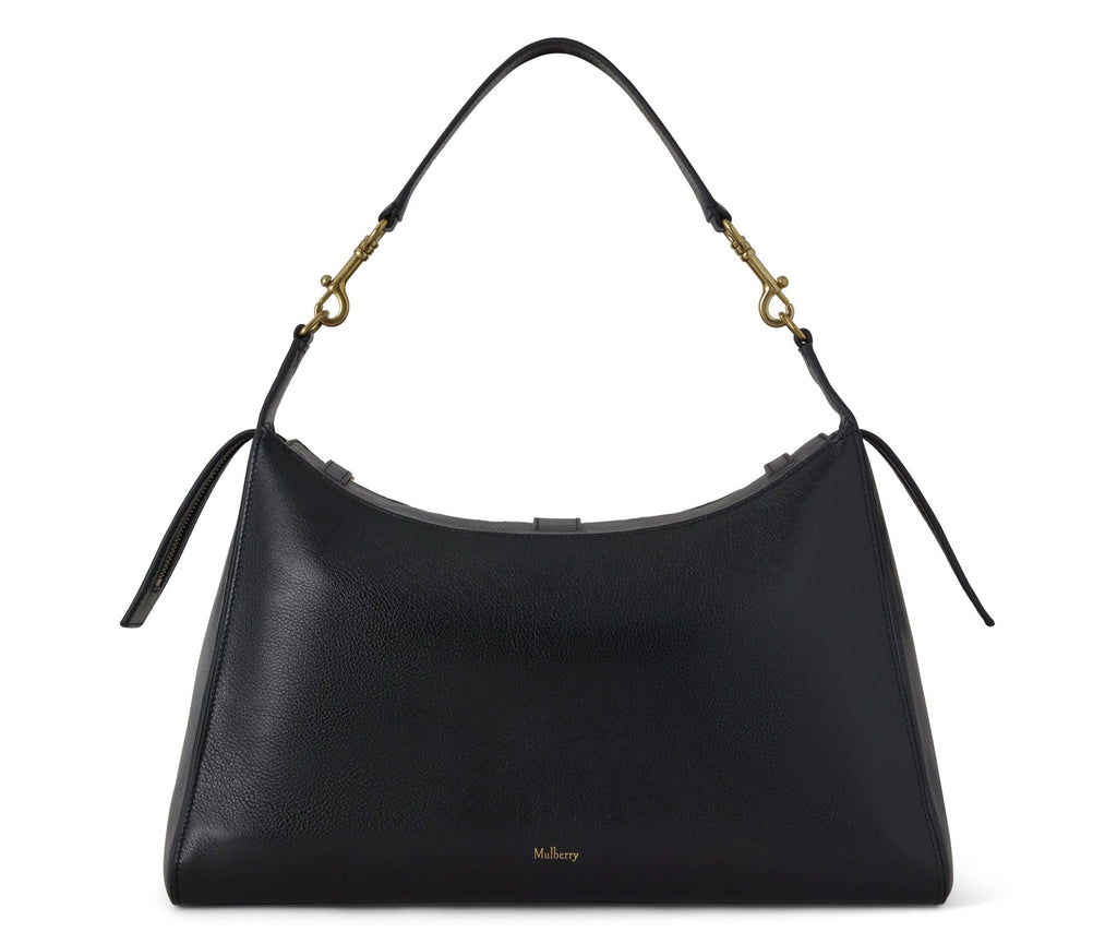 Black handbag with gold hardware on a white background