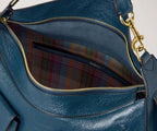 Blue leather handbag with gold zipper and plaid lining