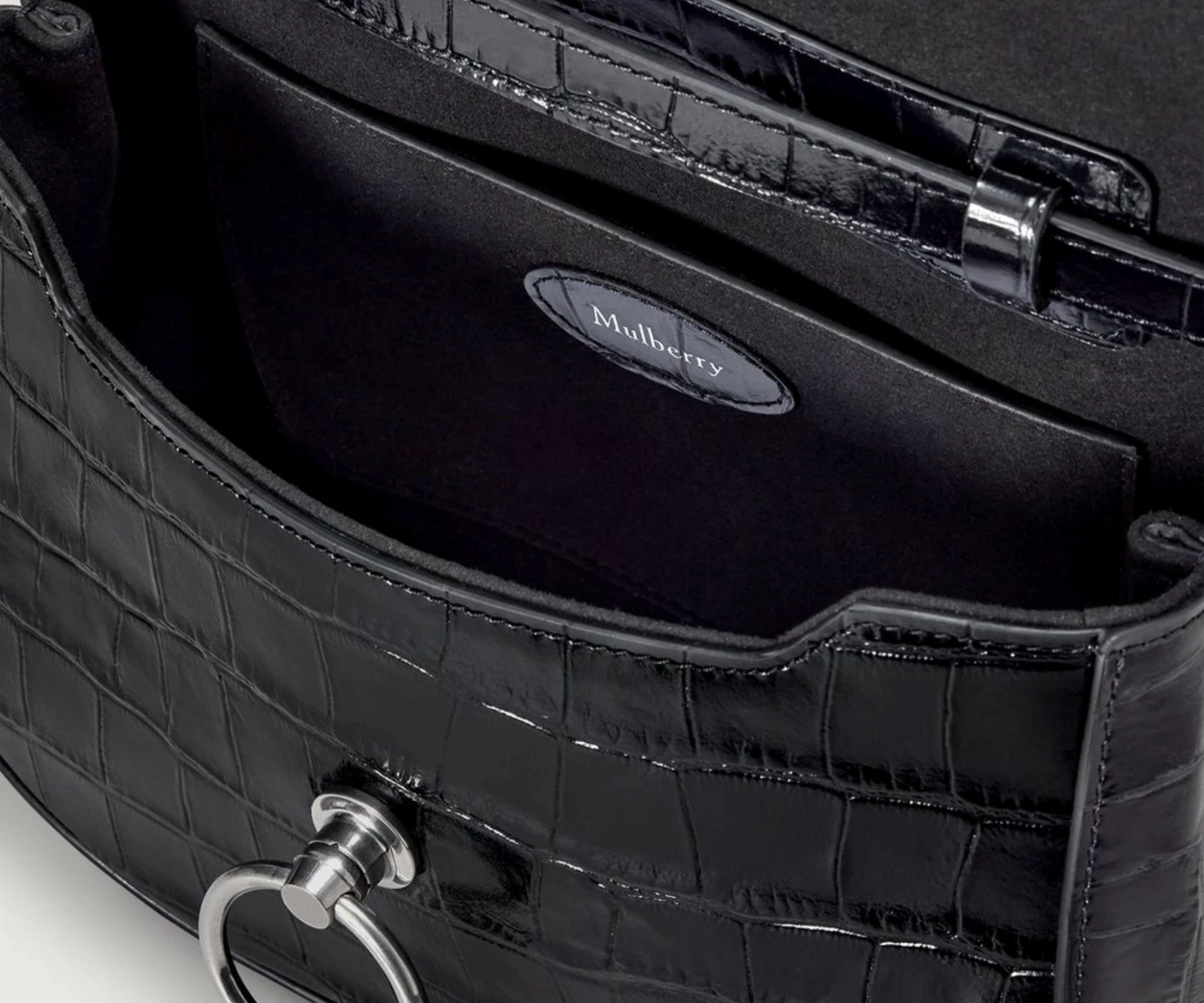 Close-up of a black handbag with 'Mulberry' branding on a white background