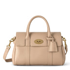 Beige handbag with gold accents on a white background