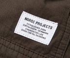 Norse Projects label on a brown fabric background