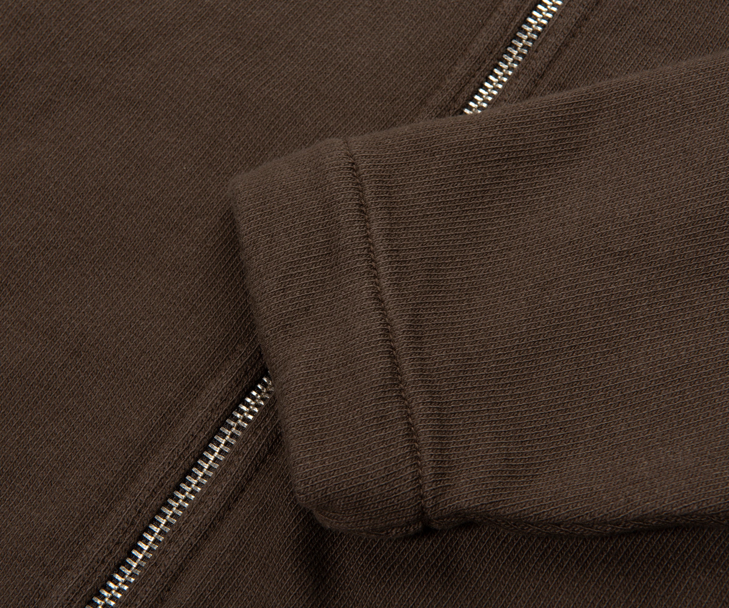 Close-up of a brown jacket with a zipper