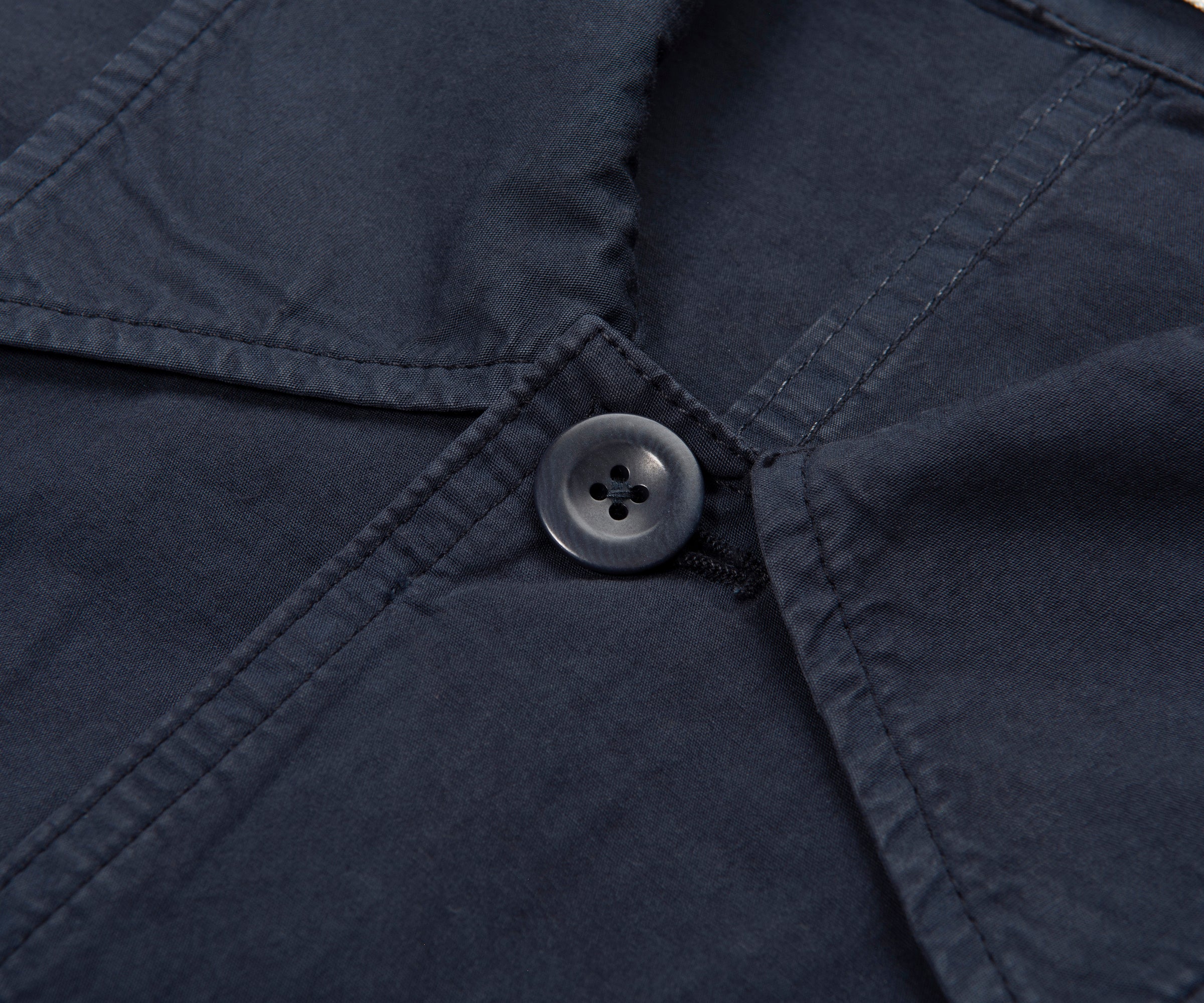Close-up of a button on a navy blue fabric