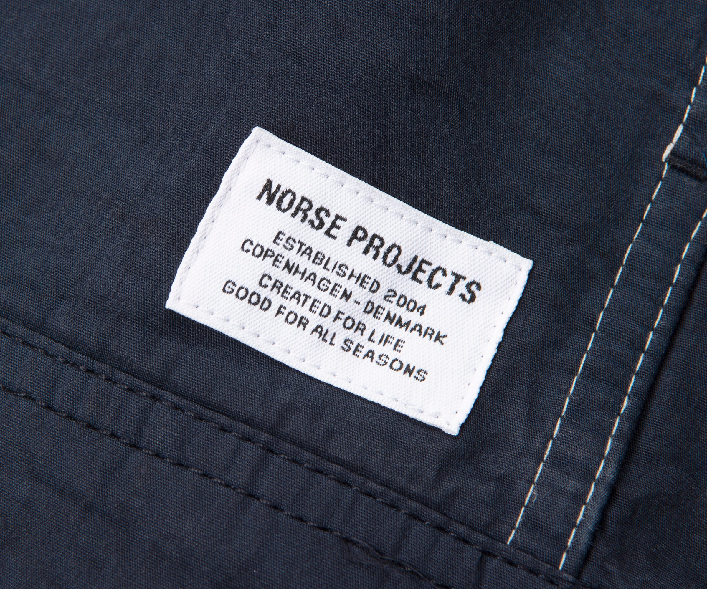 Norse Projects label on a dark fabric background