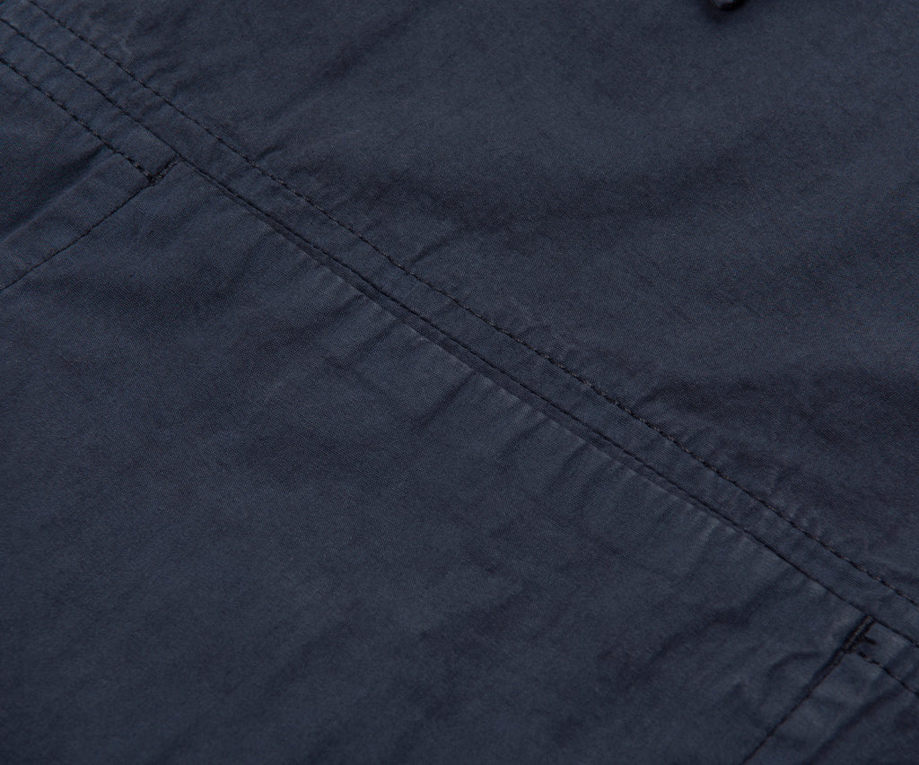 Close-up of dark blue fabric with visible stitching