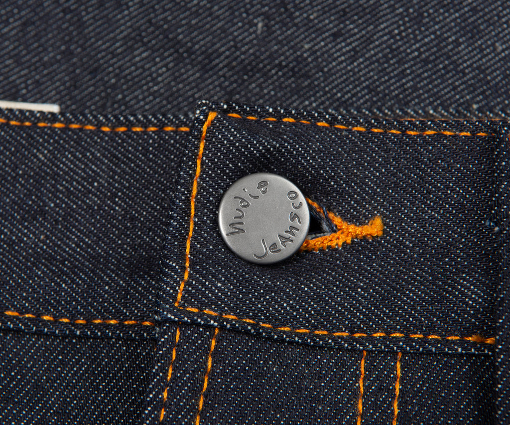 Close-up of a button on a denim fabric with 'Levi's' branding.