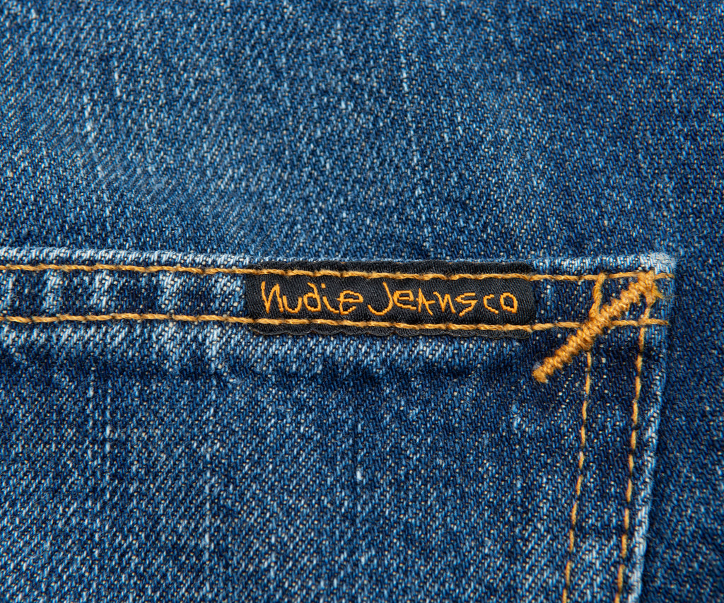 Nudie Jeans label on a blue denim fabric