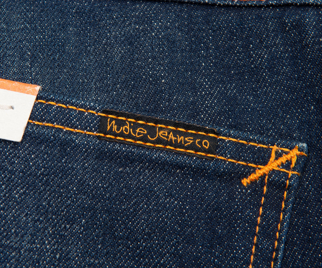 Nudie Jeans label on a blue denim fabric