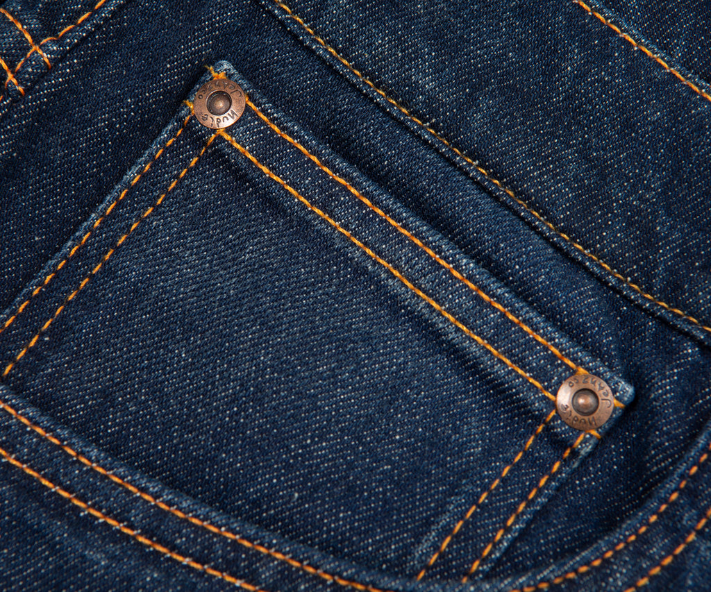 Close-up of blue denim fabric with stitching details