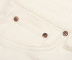Close-up of a white fabric pocket with metal buttons.