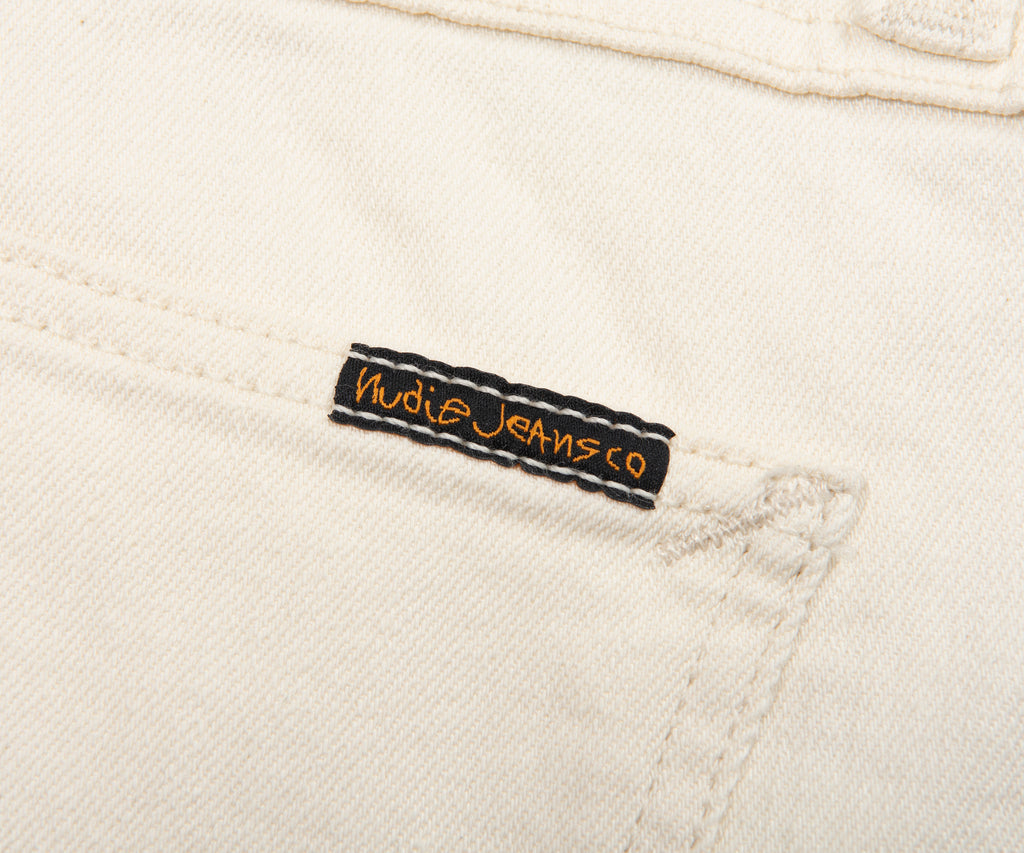 Nudie JeansCo label on a beige denim fabric