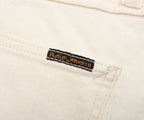 Nudie JeansCo label on a beige denim fabric