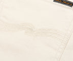 Close-up of a textured white fabric with a brand label in the corner.