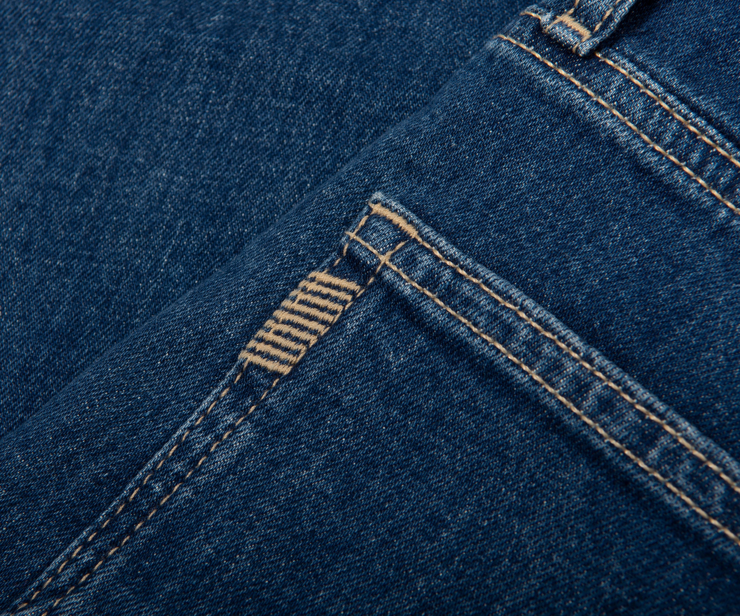 Close-up of blue denim fabric with stitching detail