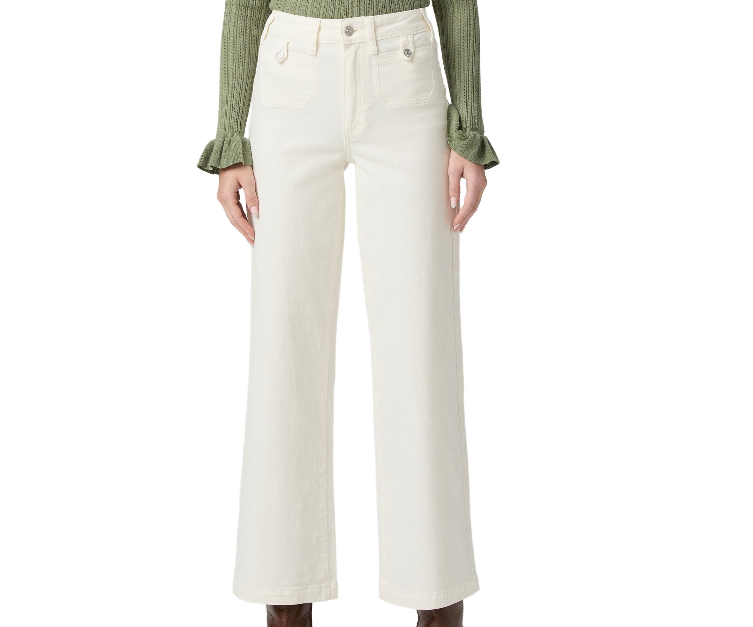 Person wearing white wide-leg pants with a green top on a white background