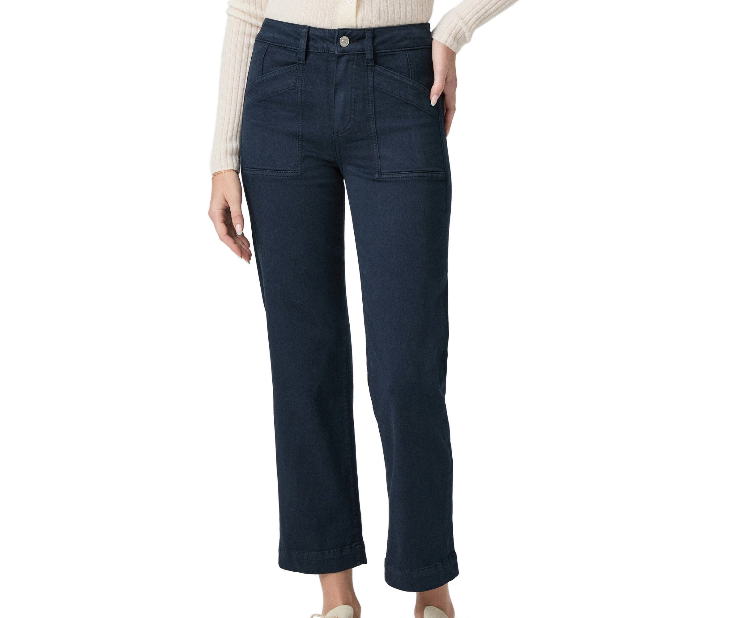 Navy blue jeans worn by a person on a white background