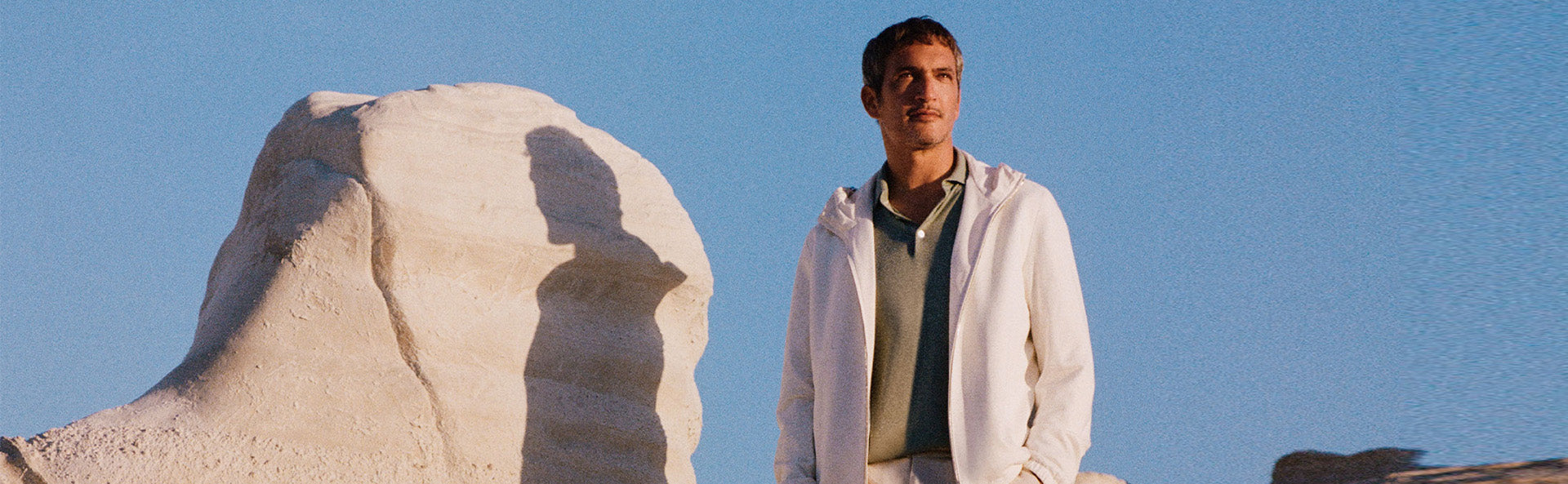 Paul & Shark model wearing designer outerwear in a desert landscape on a sunny day