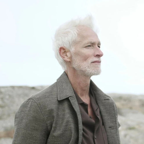 Herno male model wearing designer outerwear outdoors, showcasing style and fit.