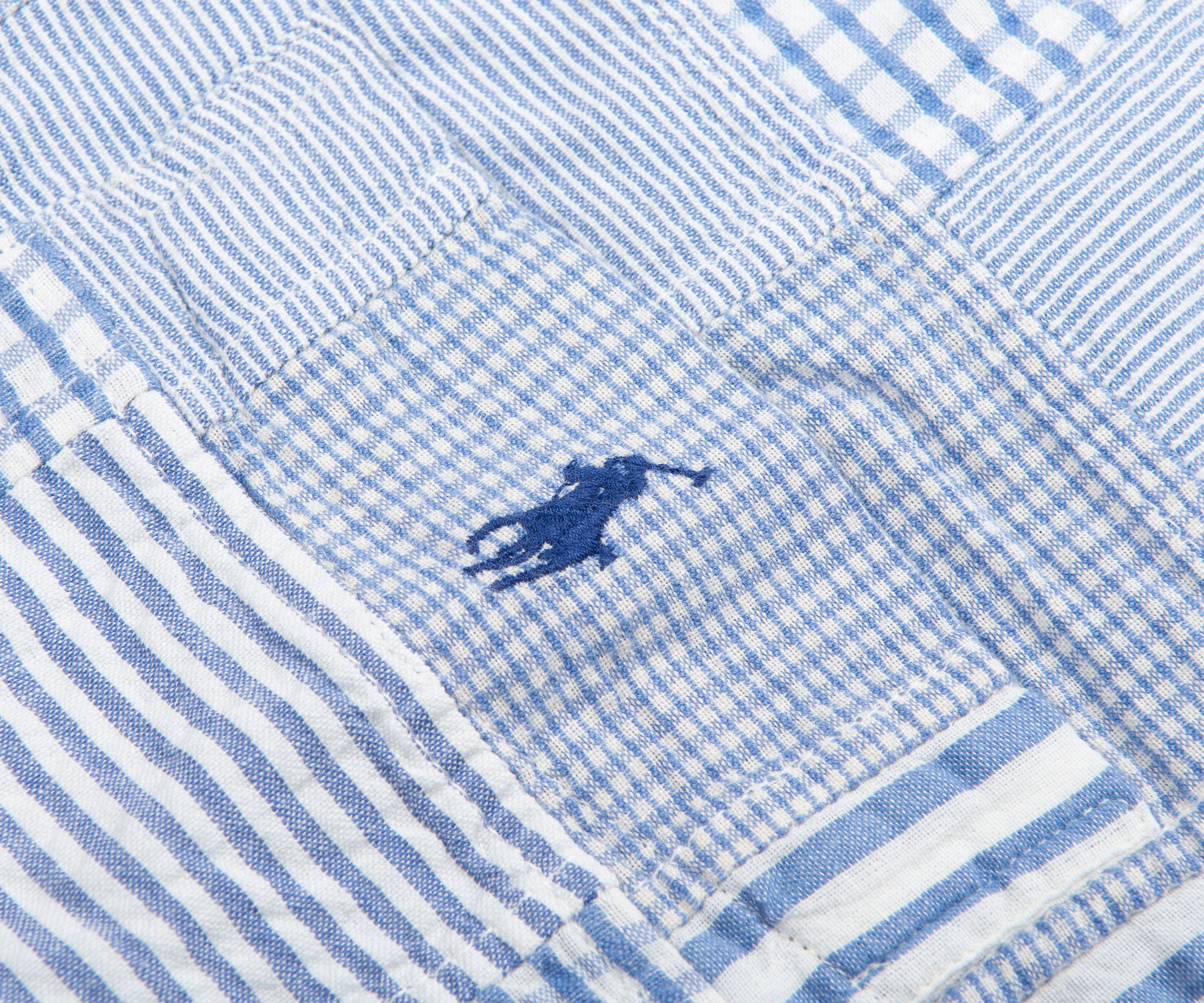 Close-up of a blue and white striped fabric with a small logo.