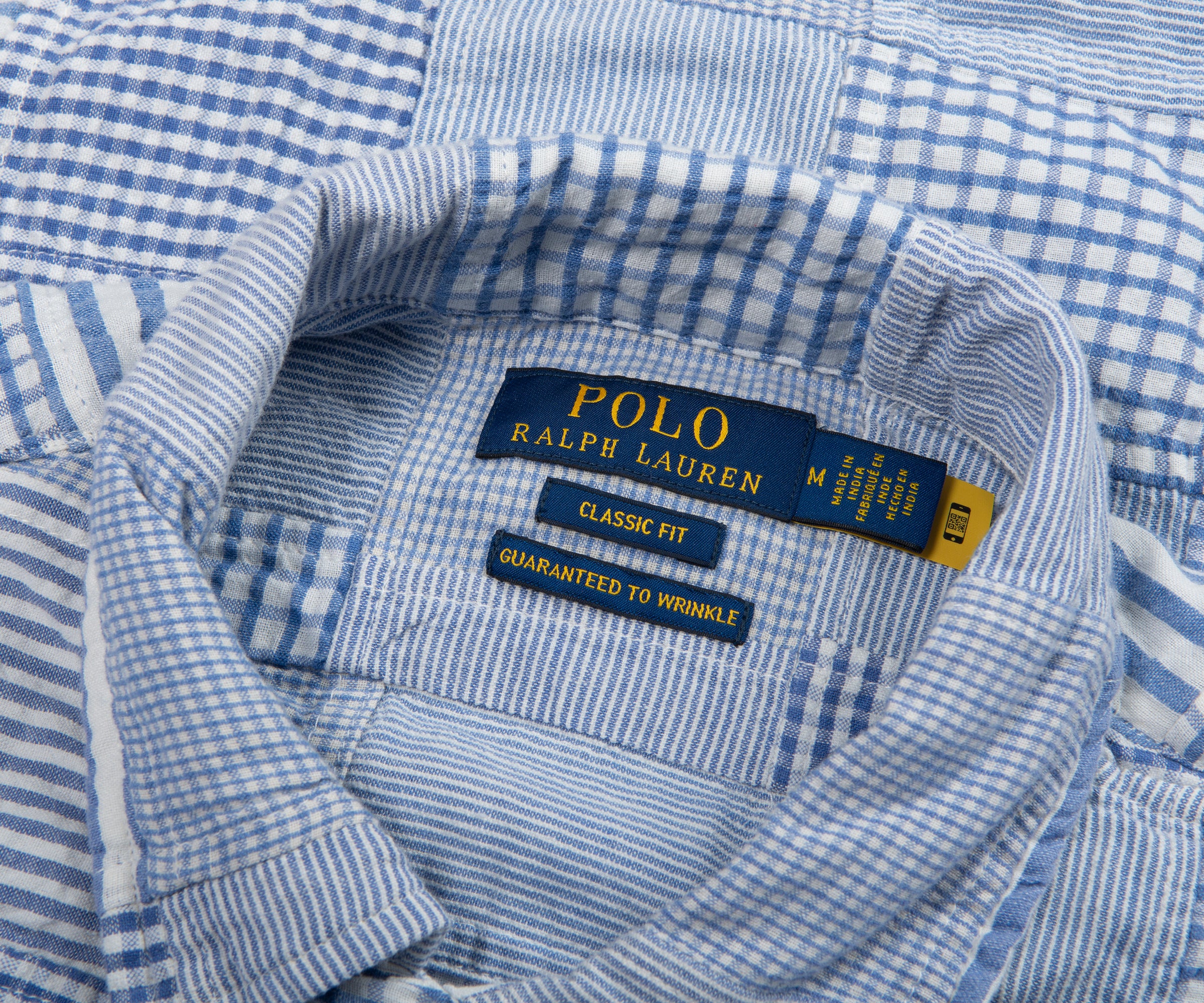 Close-up of a blue and white checkered shirt with Polo Ralph Lauren label.
