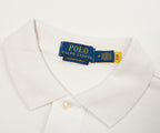 Close-up of a white shirt with a Polo Ralph Lauren tag on a light gray background