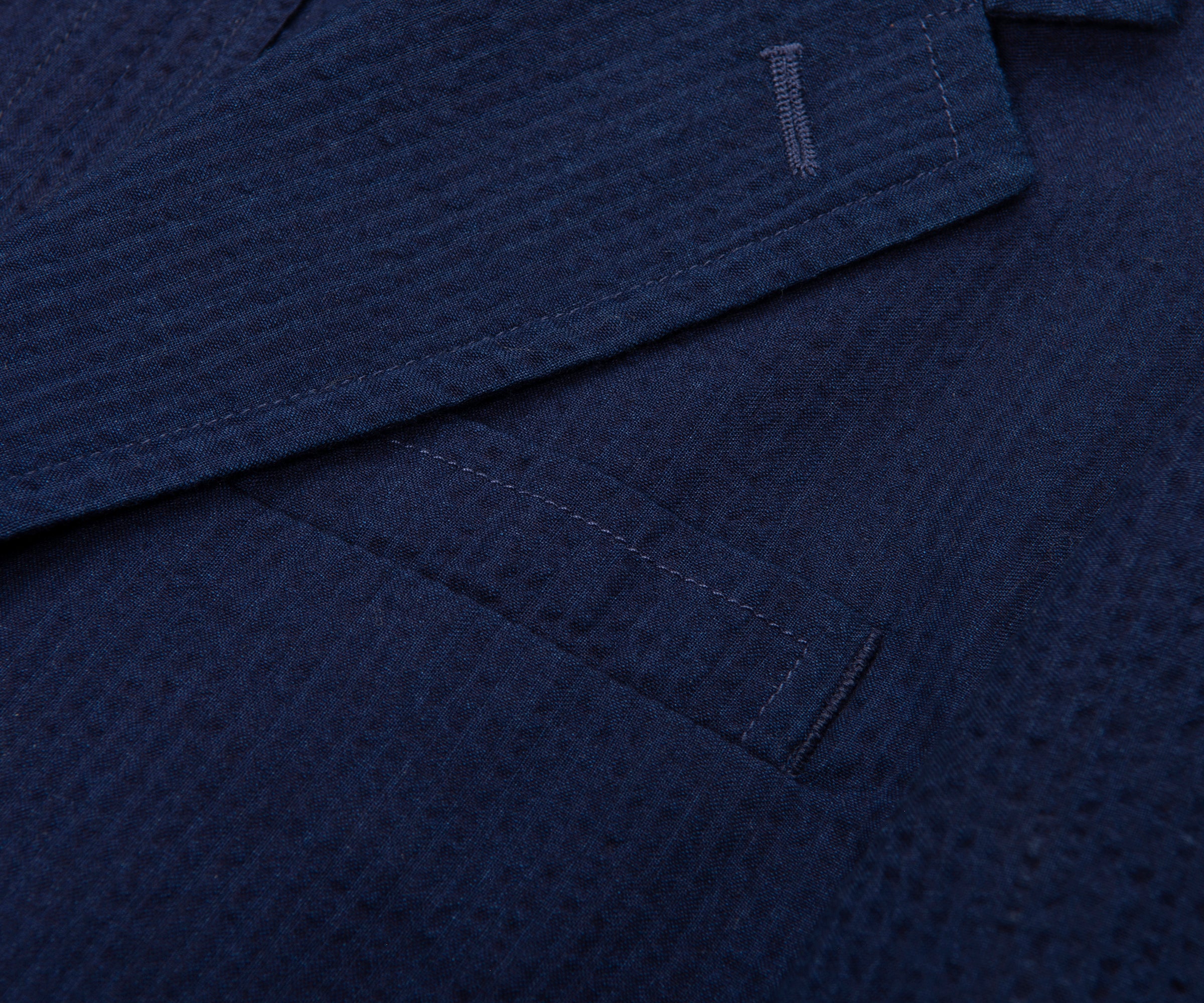 Close-up of a textured navy fabric with stitching details