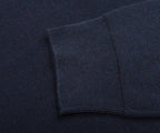 Close-up of a dark blue textured fabric with a folded edge.