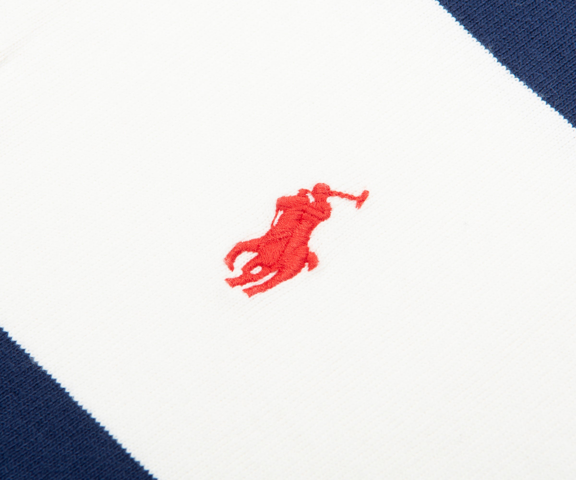 Close-up of a red logo on a white and blue striped background