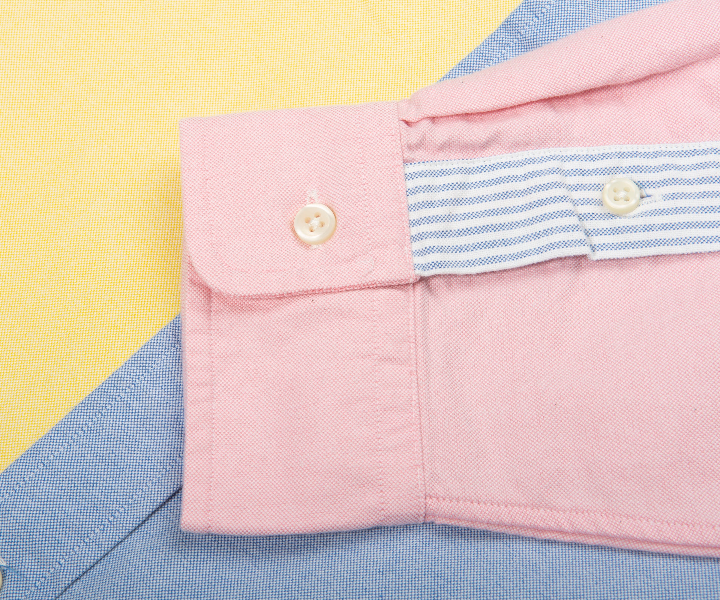 Close-up of a pink shirt with a yellow and blue background