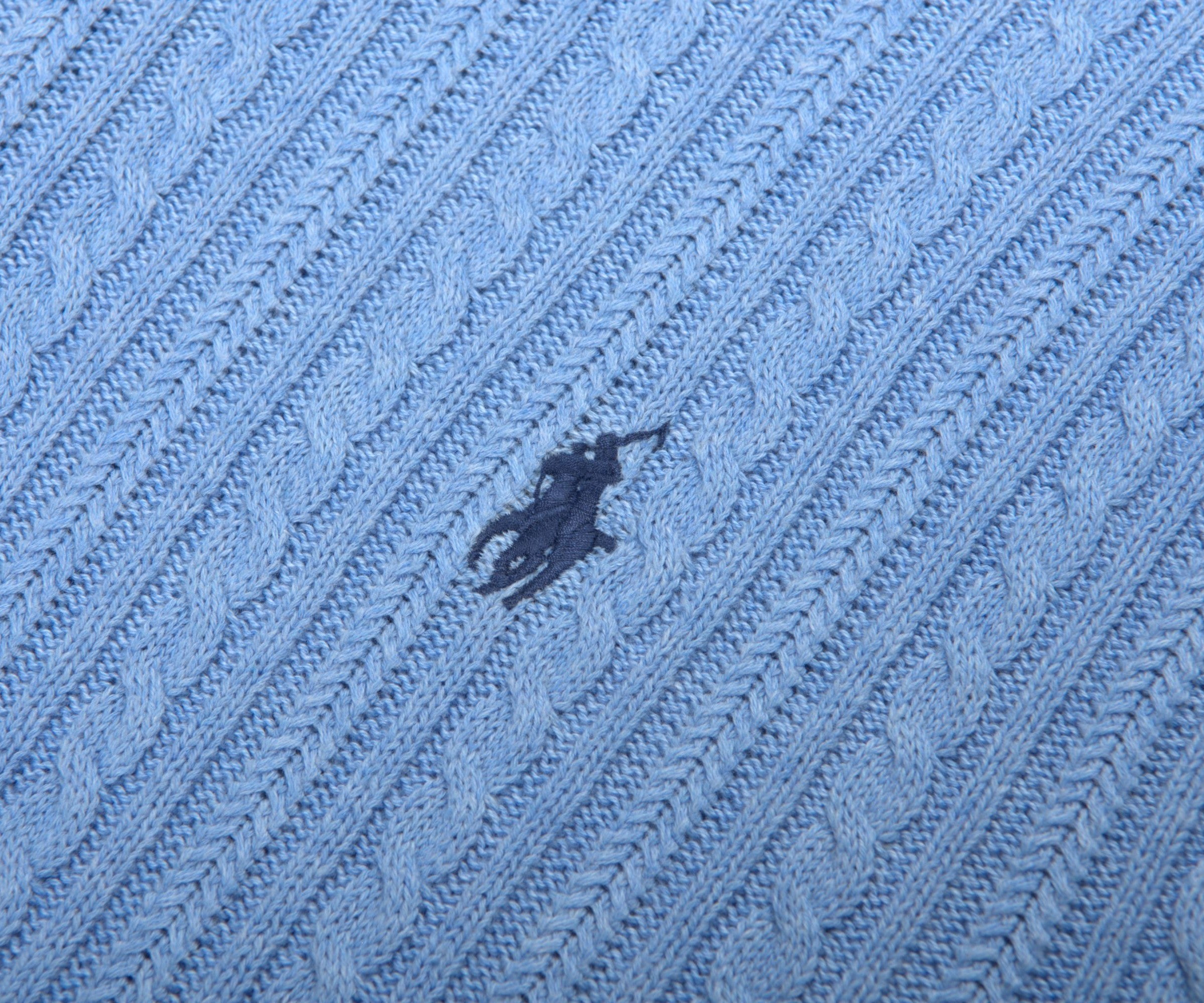 Close-up of a blue textured fabric with a logo in the center.