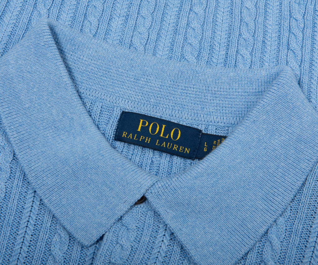 Close-up of a blue sweater with a Polo Ralph Lauren label.