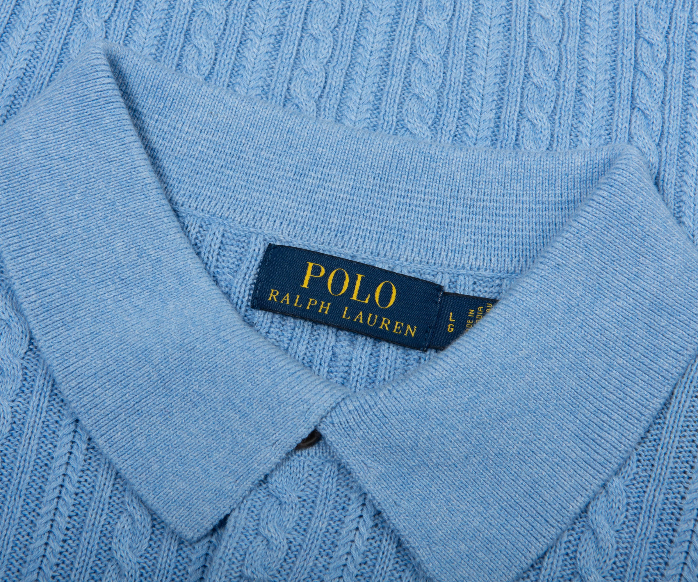 Close-up of a blue sweater with a Polo Ralph Lauren label.