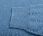 Close-up of a blue textured fabric with a pocket detail