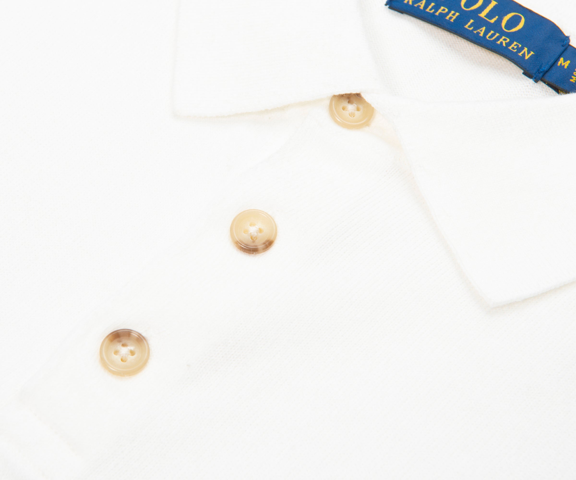 Pearl earrings on a white background with Ralph Lauren box.