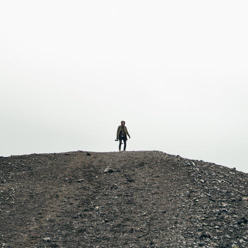Man standing on gravel hill outdoors at Pockets outlet
