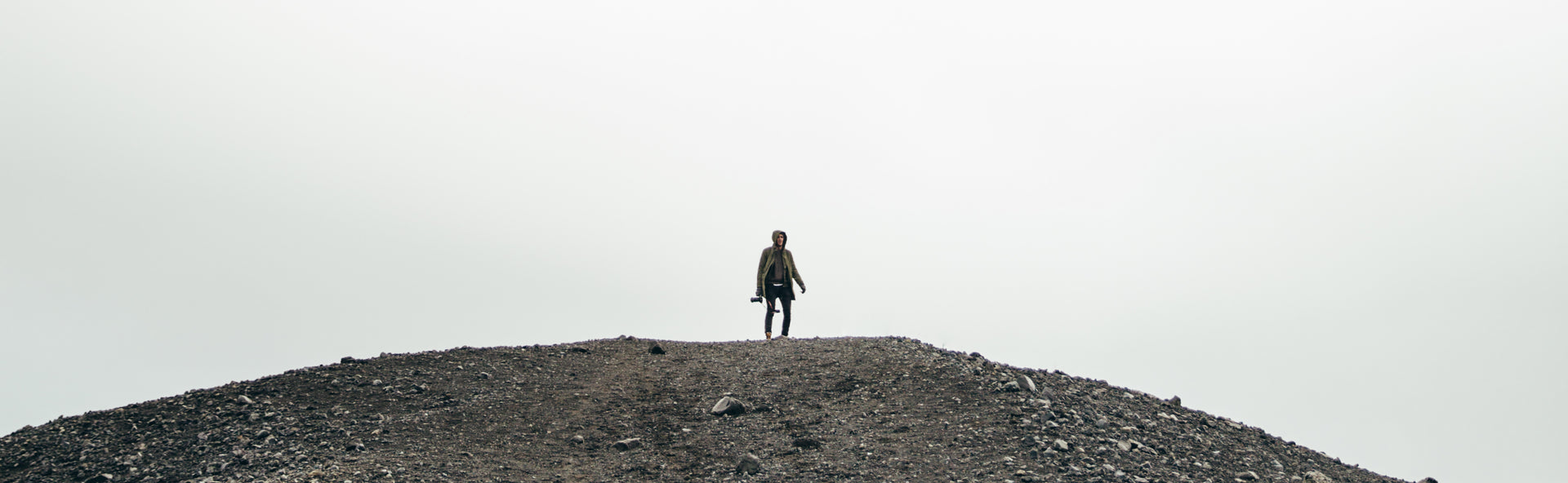 Man standing on gravel hill outdoors at Pockets outlet
