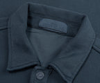 Close-up of a dark gray polo shirt with Stone Island label