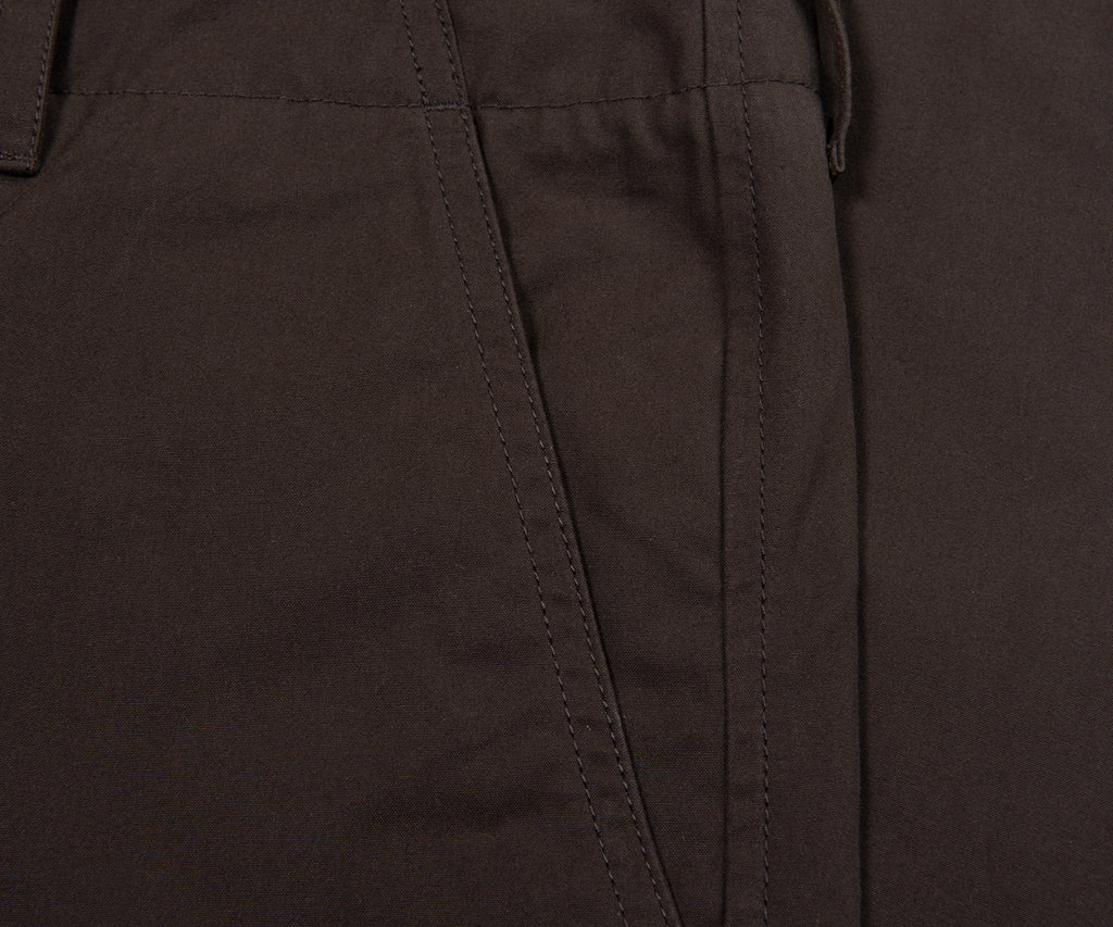 Close-up of dark brown pants with a focus on texture and stitching.