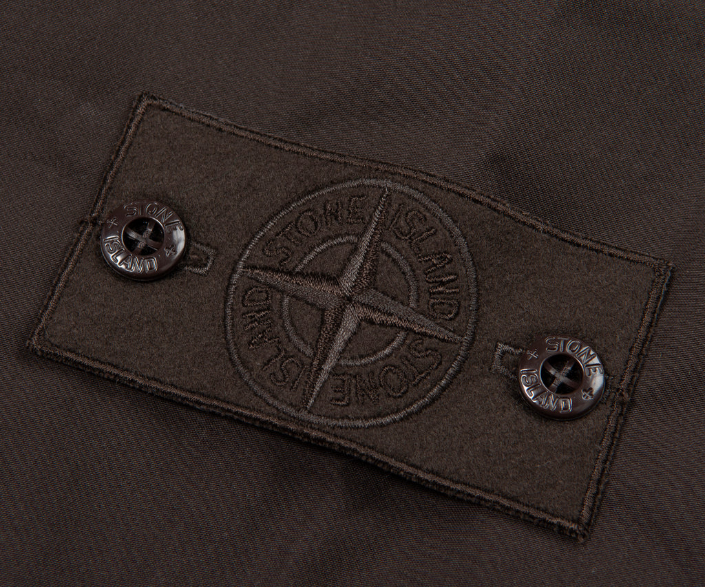 Close-up of a brand label on a dark fabric background
