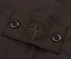 Close-up of a brand label on a dark fabric background
