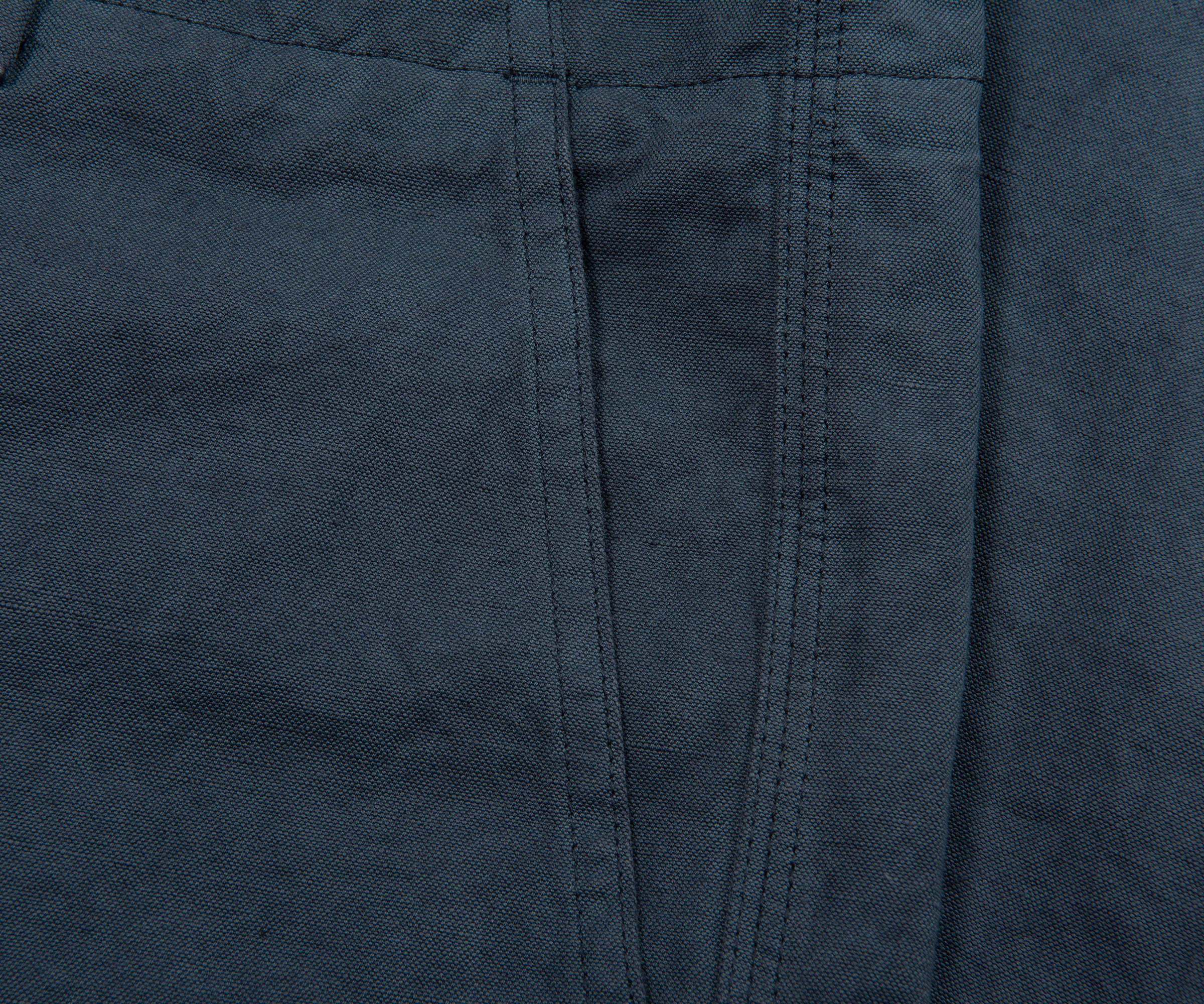 Close-up of dark blue fabric with a visible seam