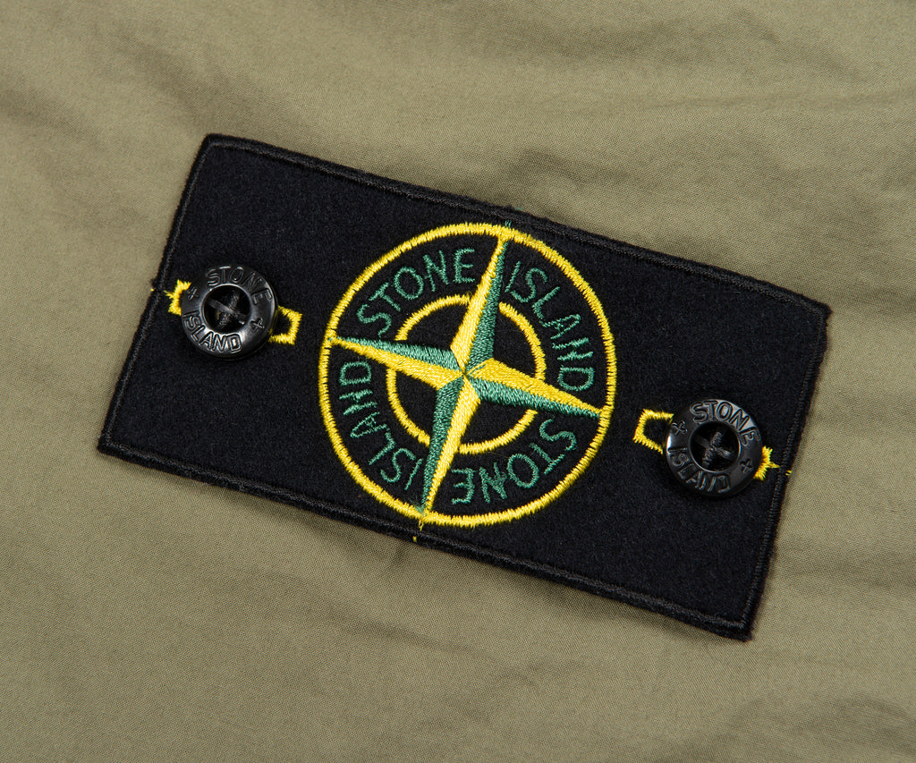 Stone Island patch on a green background
