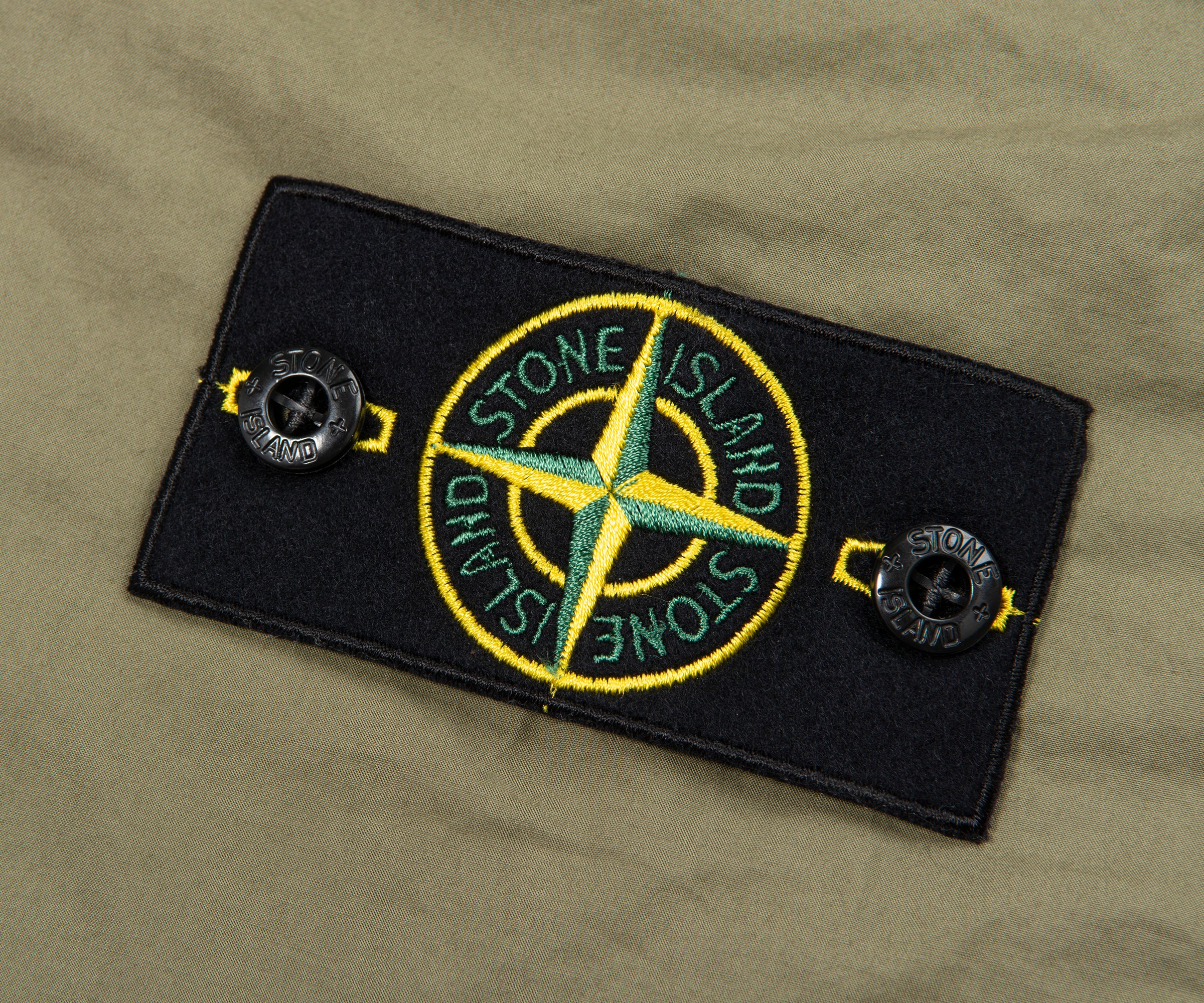 Stone Island patch on a green background