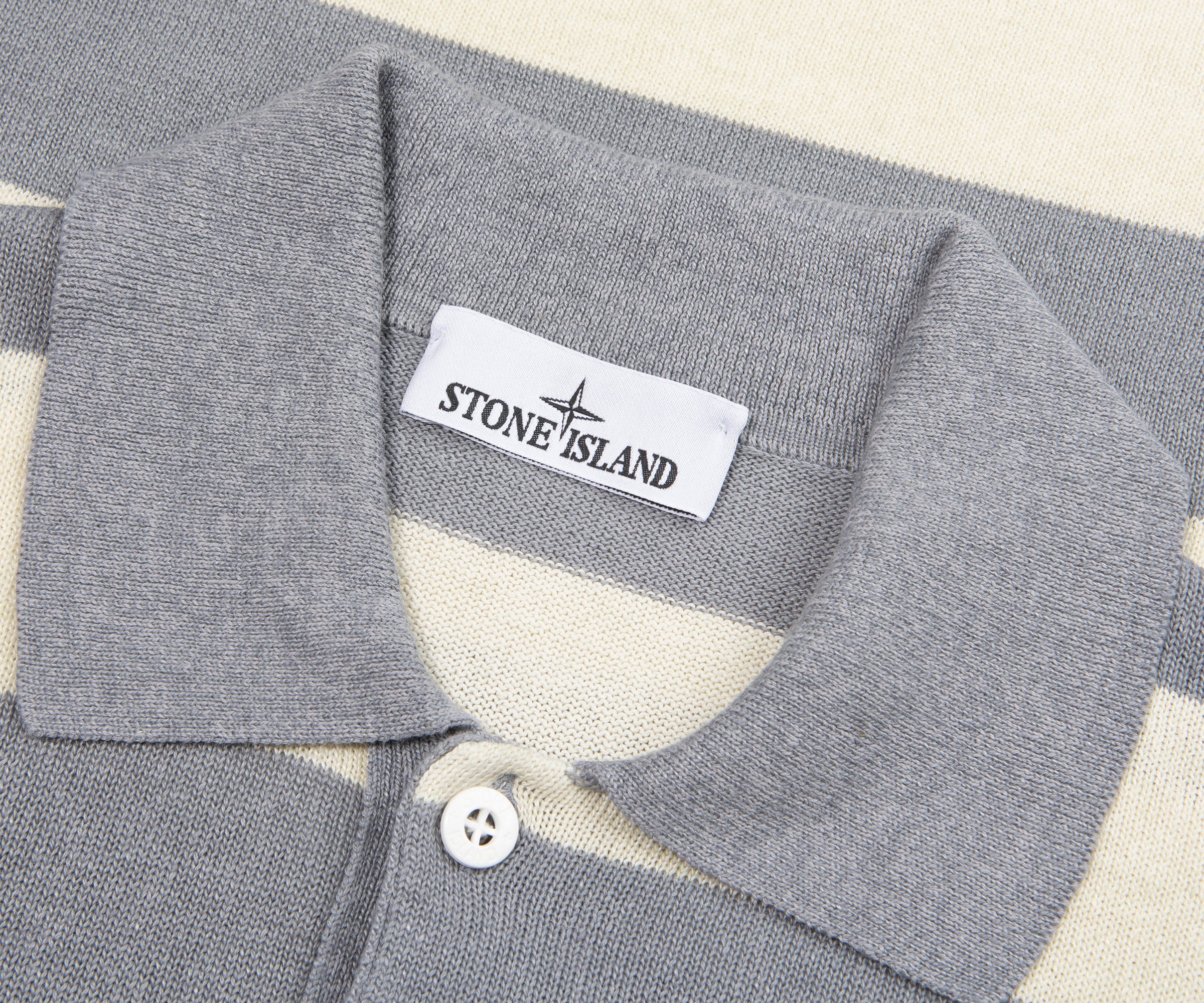 Close-up of a gray polo shirt collar with Stone Island label