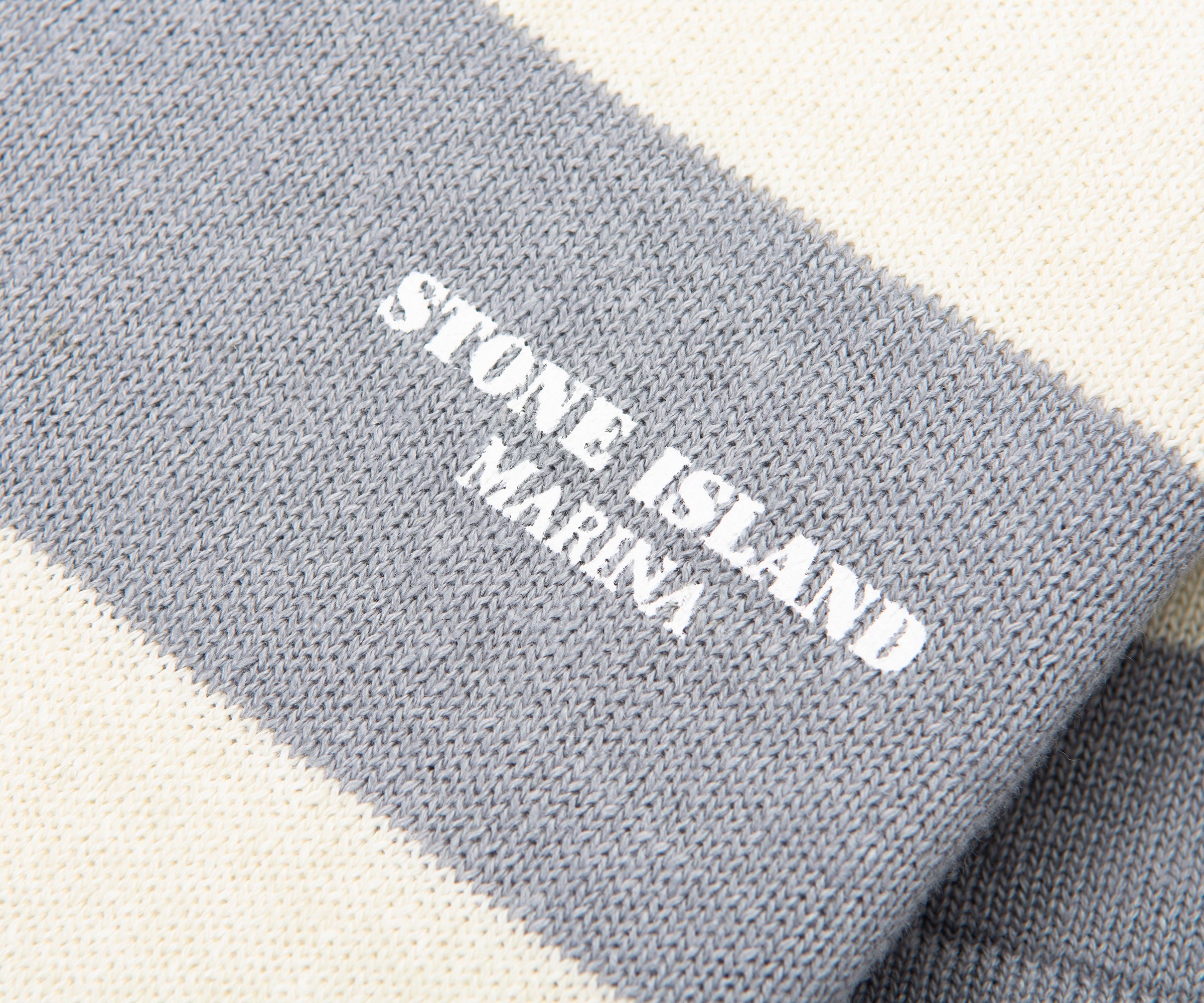 Gray fabric with 'Stone Island Marina' logo on a white background