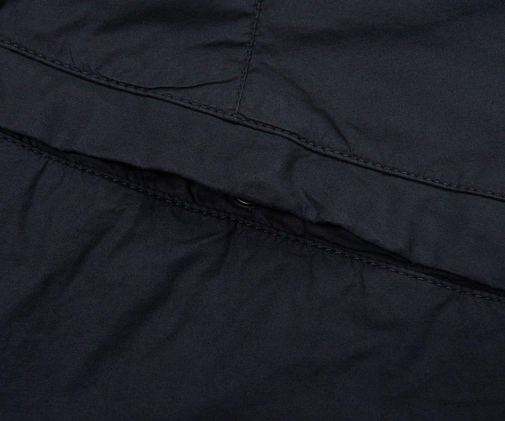Close-up of a black quilted jacket with stitching detail