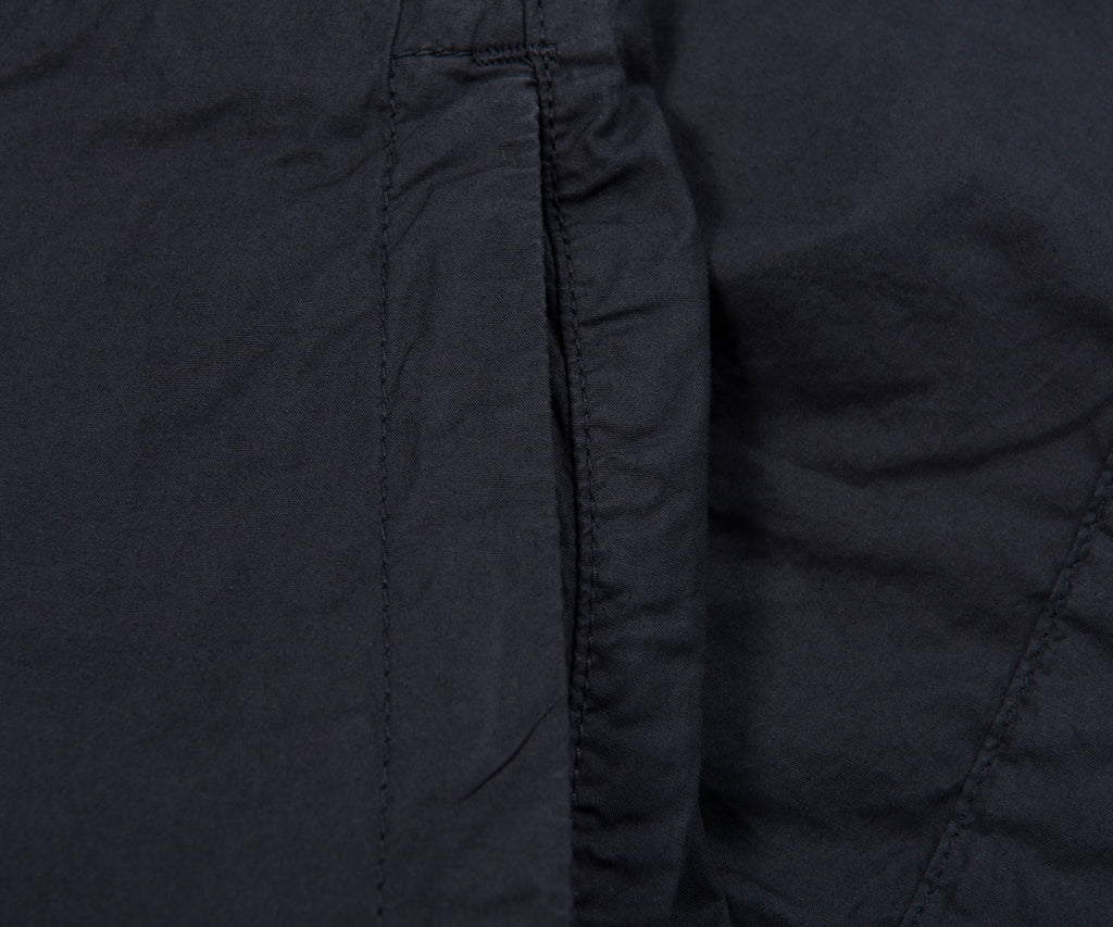 Close-up of a dark gray quilted jacket with stitching details.