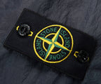 Stone Island logo patch on a dark fabric background