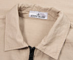 Close-up of a beige jacket with a Stone Island label.